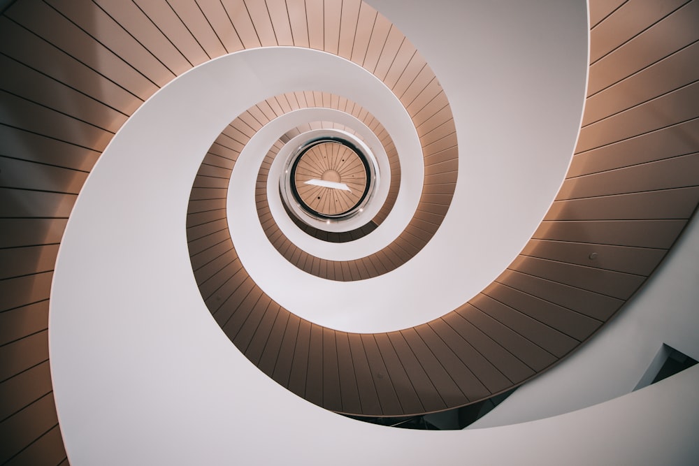 a spiral staircase with a clock in the center