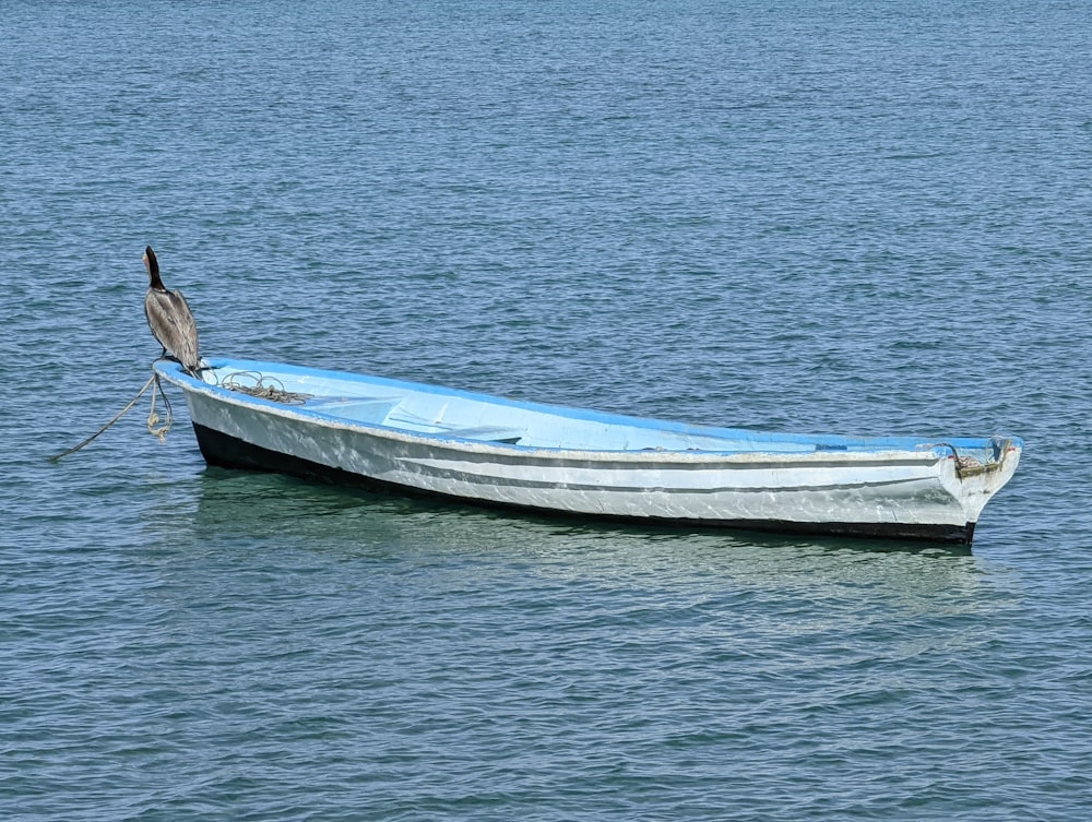 a small boat floating on top of a body of water