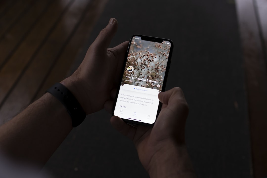 a person holding a cell phone in their hand,