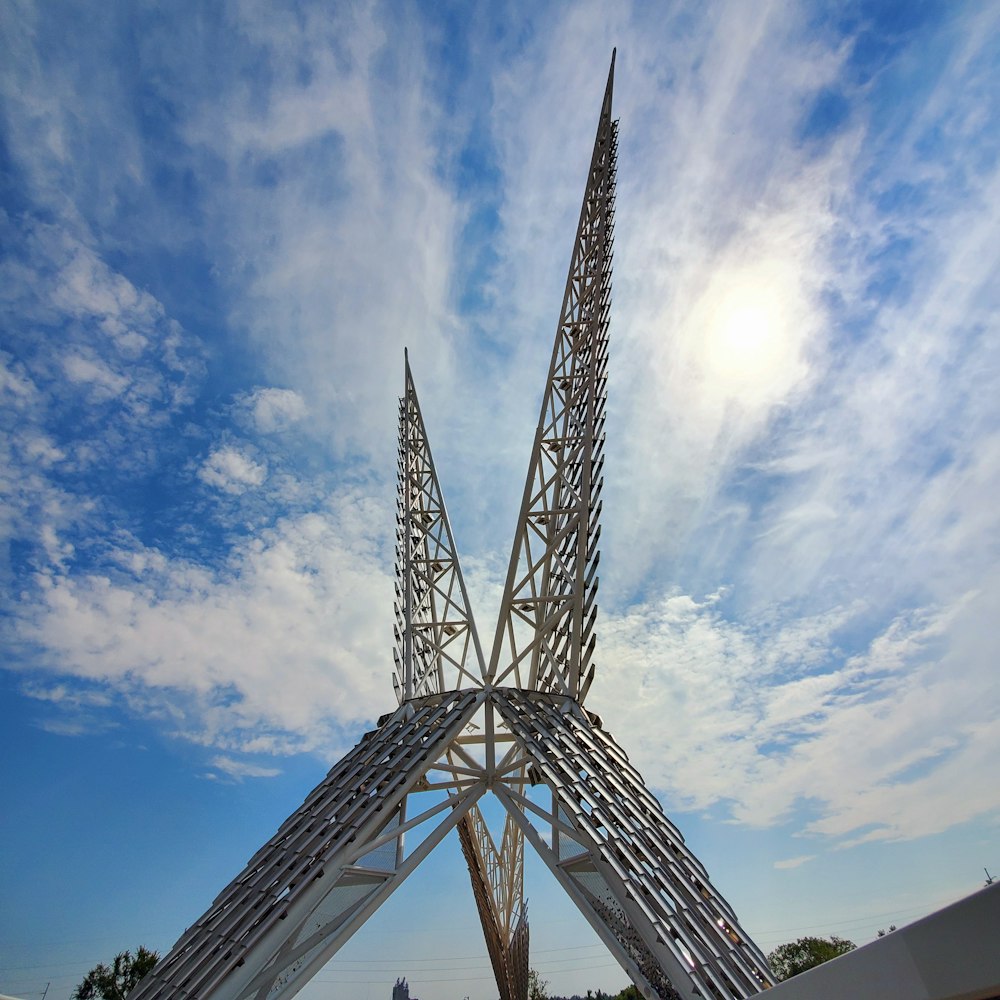 a very tall metal structure sitting under a blue sky