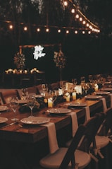 a long table is set with candles and place settings