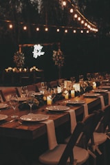 a long table is set with candles and place settings