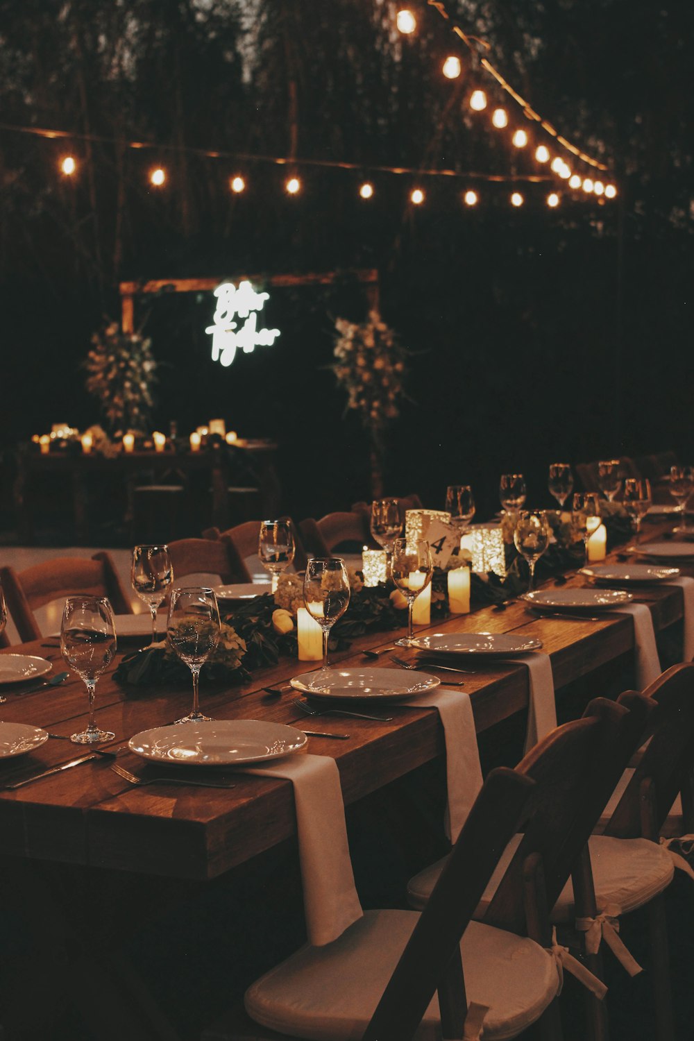 a long table is set with candles and place settings