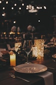 a dinner table with candles and place settings