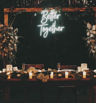 a wooden table topped with candles and flowers