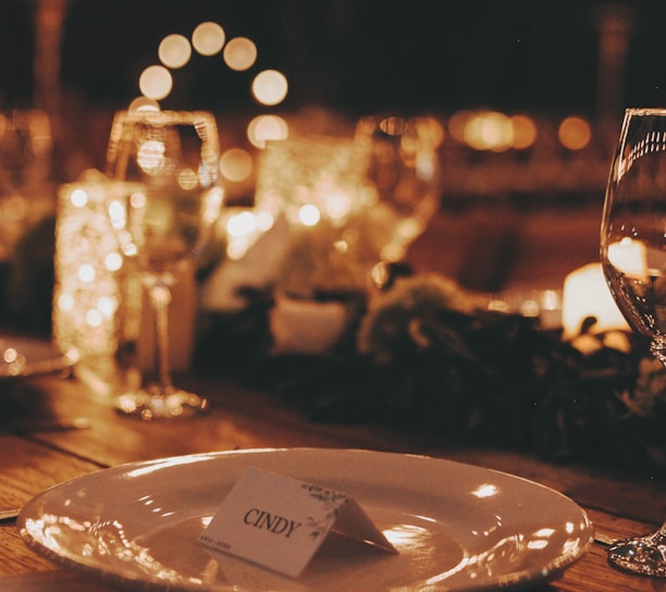 a table with a plate and wine glasses on it