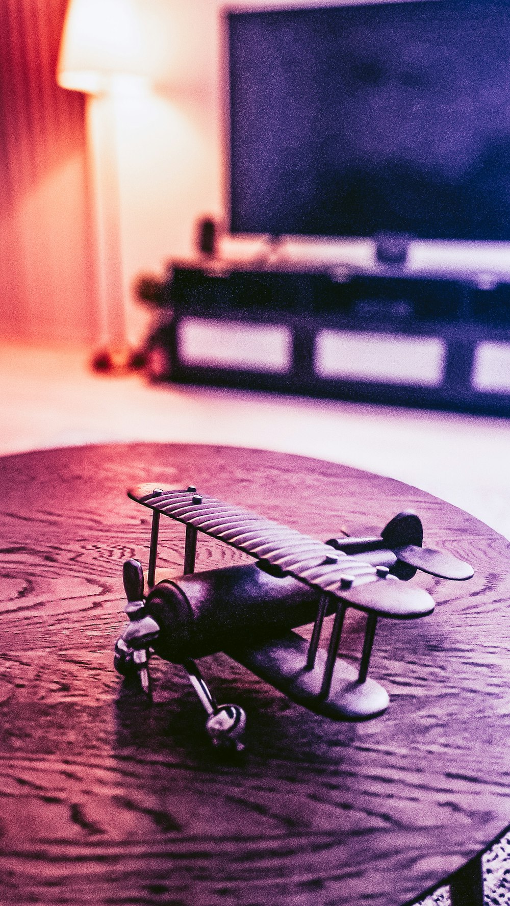 a toy airplane sitting on top of a wooden table