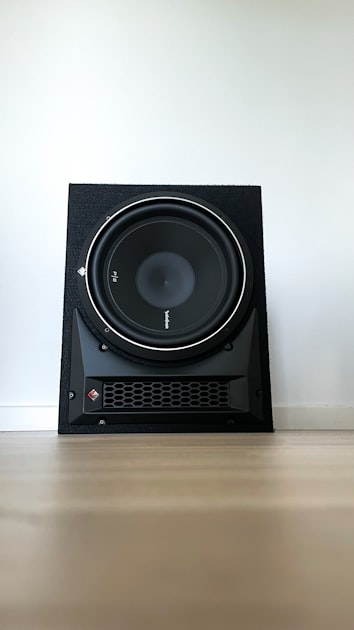 Rockford Fosgate P2 subwoofer mounted in a ported black enclosure showing the driver cone and surround