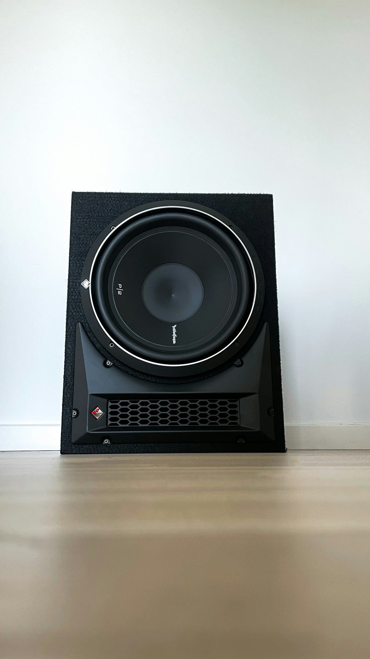 A subwoofer on a hardwood floor