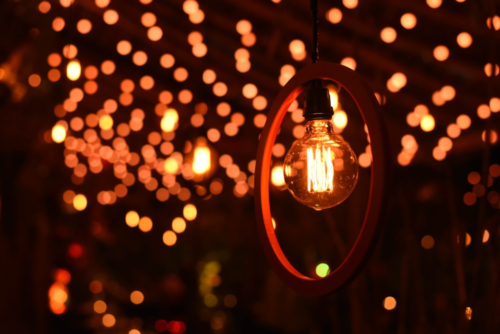a light bulb hanging from a ceiling covered in lights