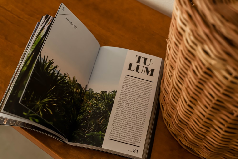 an open magazine sitting on top of a wooden table