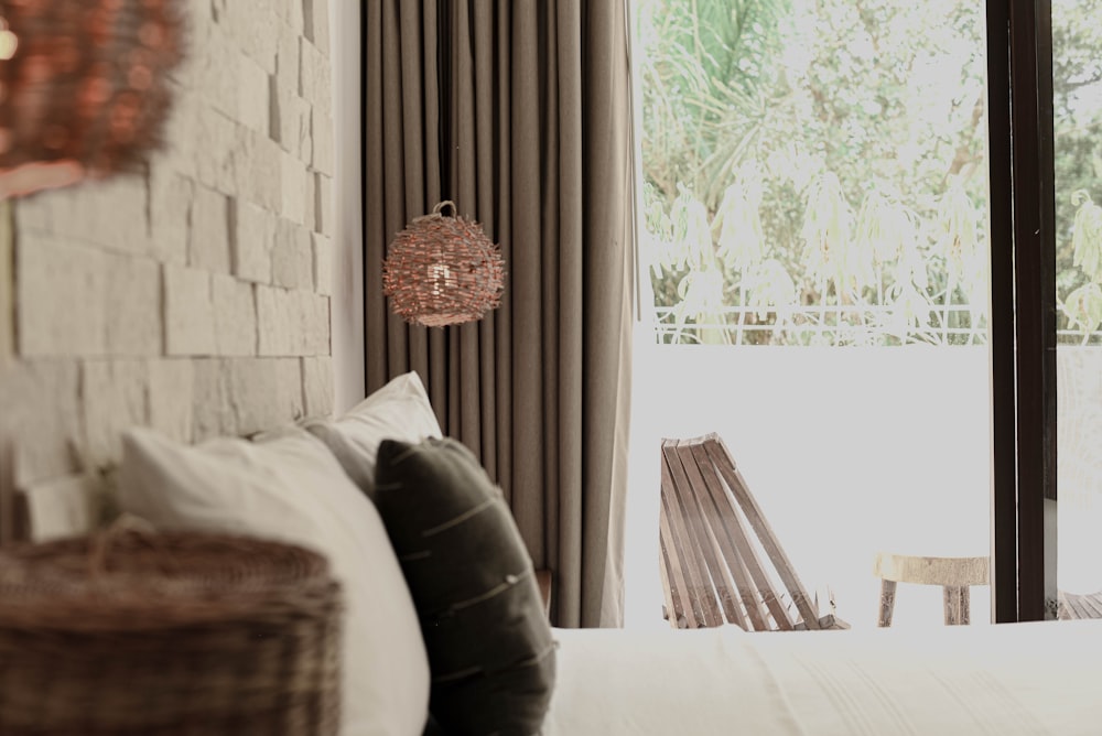 a bedroom with a brick wall and a white bed