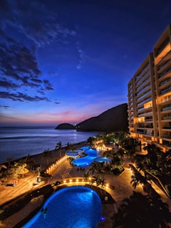a large swimming pool next to a tall building