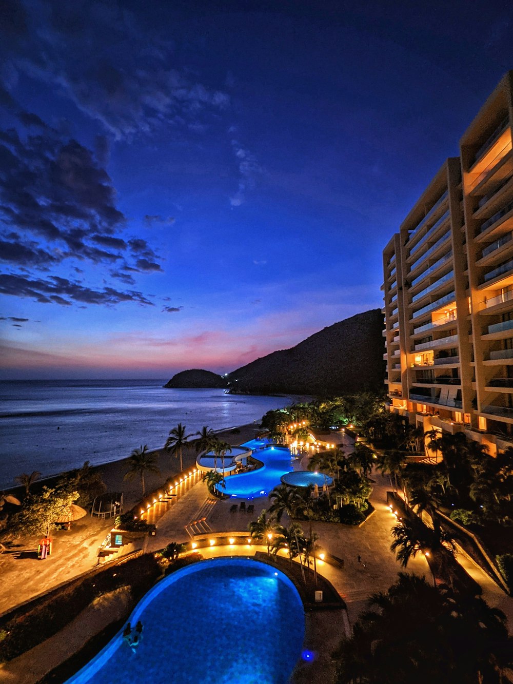 a large swimming pool next to a tall building