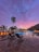 A serene backyard pool area at sunset with elegant lighting and tropical plants.