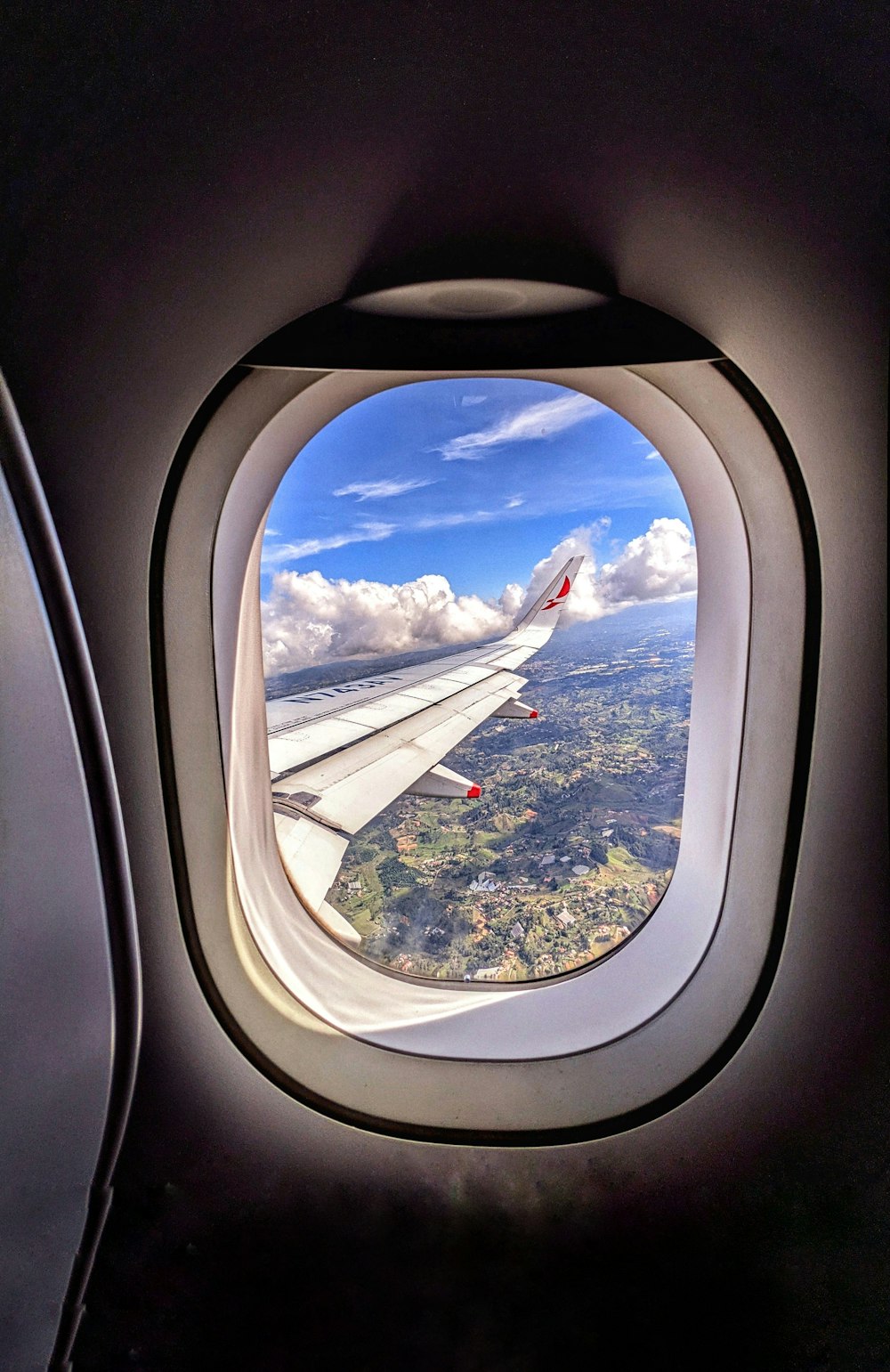 a view of the wing of an airplane through a window