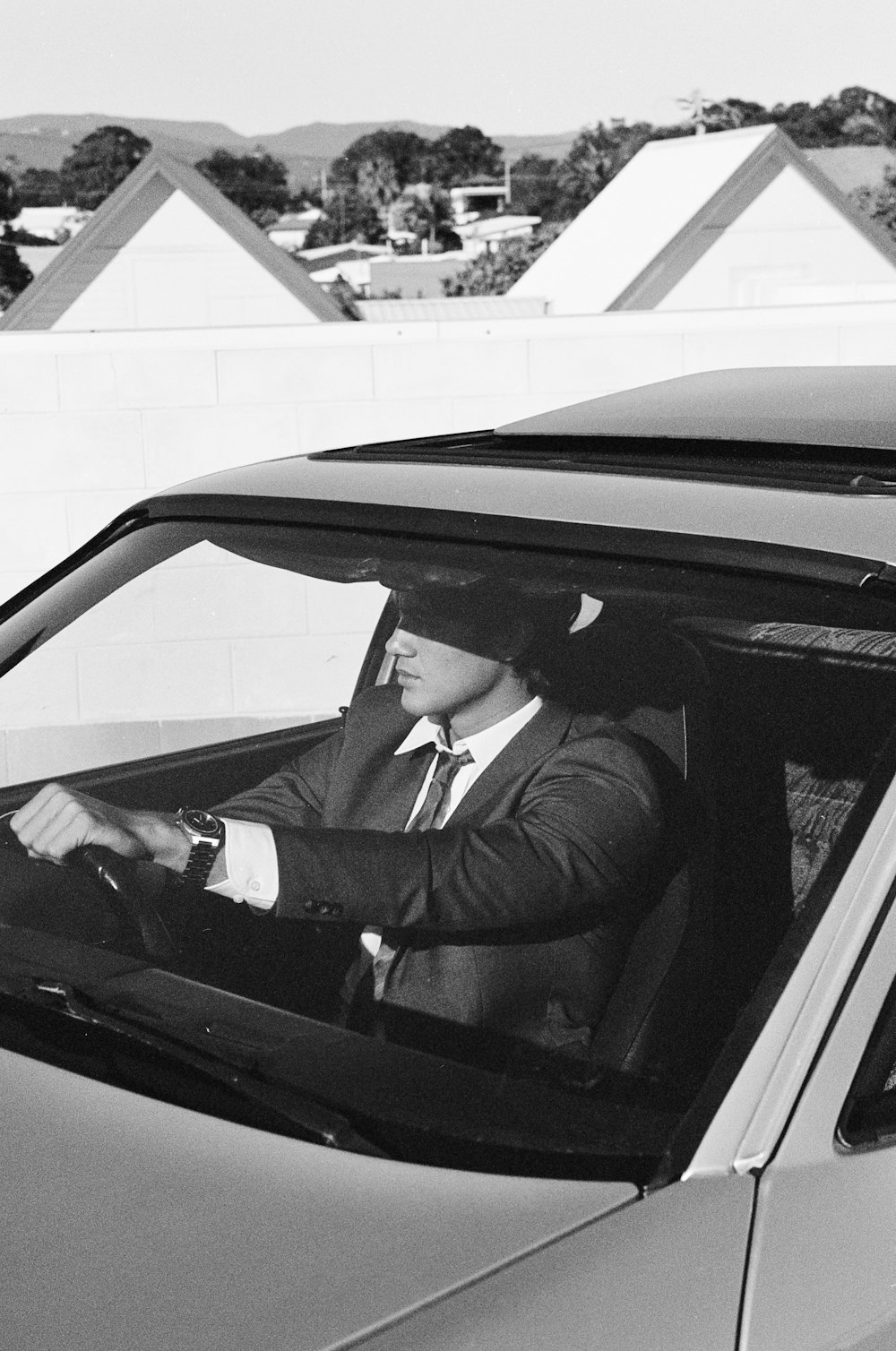 a man in a suit sitting in a car