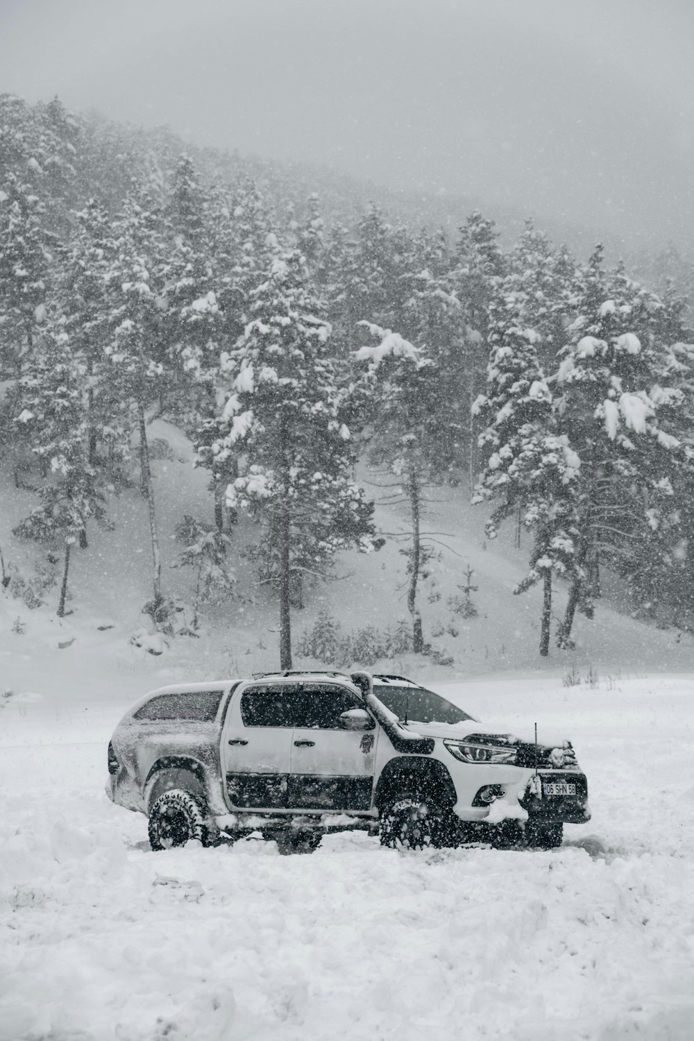 a truck is parked in a snowy field