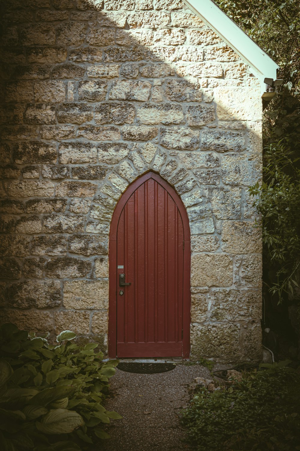 una porta rossa è in un edificio in pietra