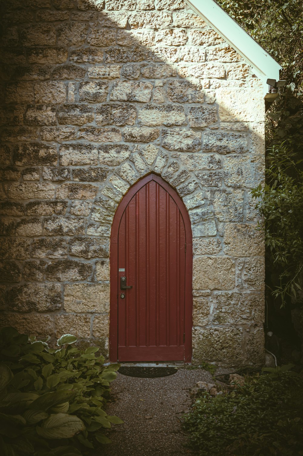 a red door is in a stone building