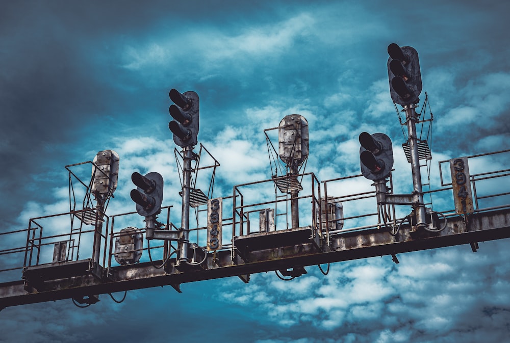 a group of traffic lights sitting on top of a metal structure