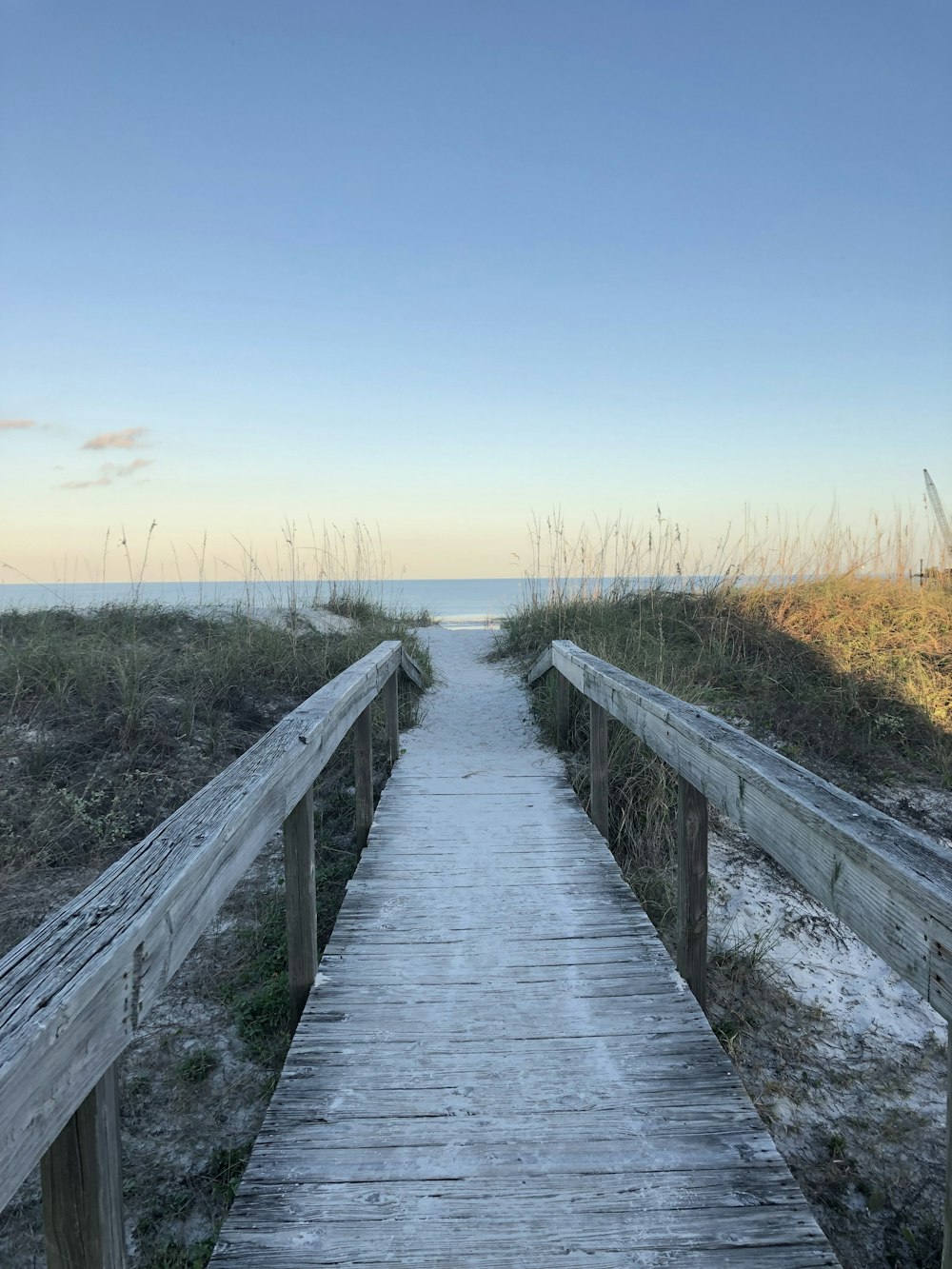 a wooden walkway leading to the beach