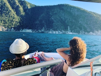 a couple of people sitting on a boat in the water