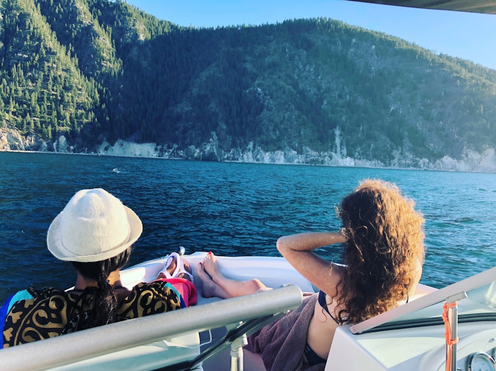 a couple of people sitting on a boat in the water