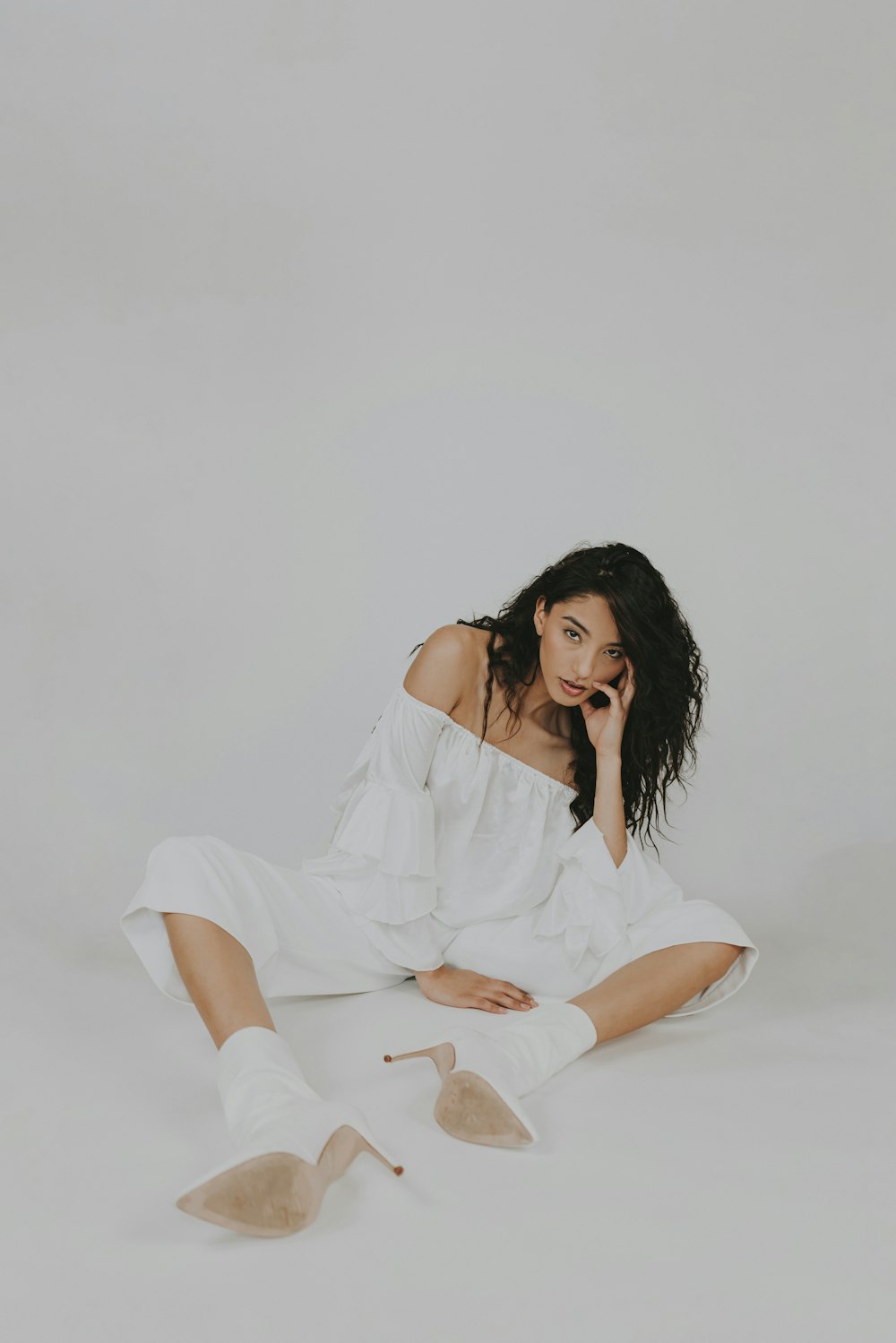 a woman sitting on the floor with her legs crossed