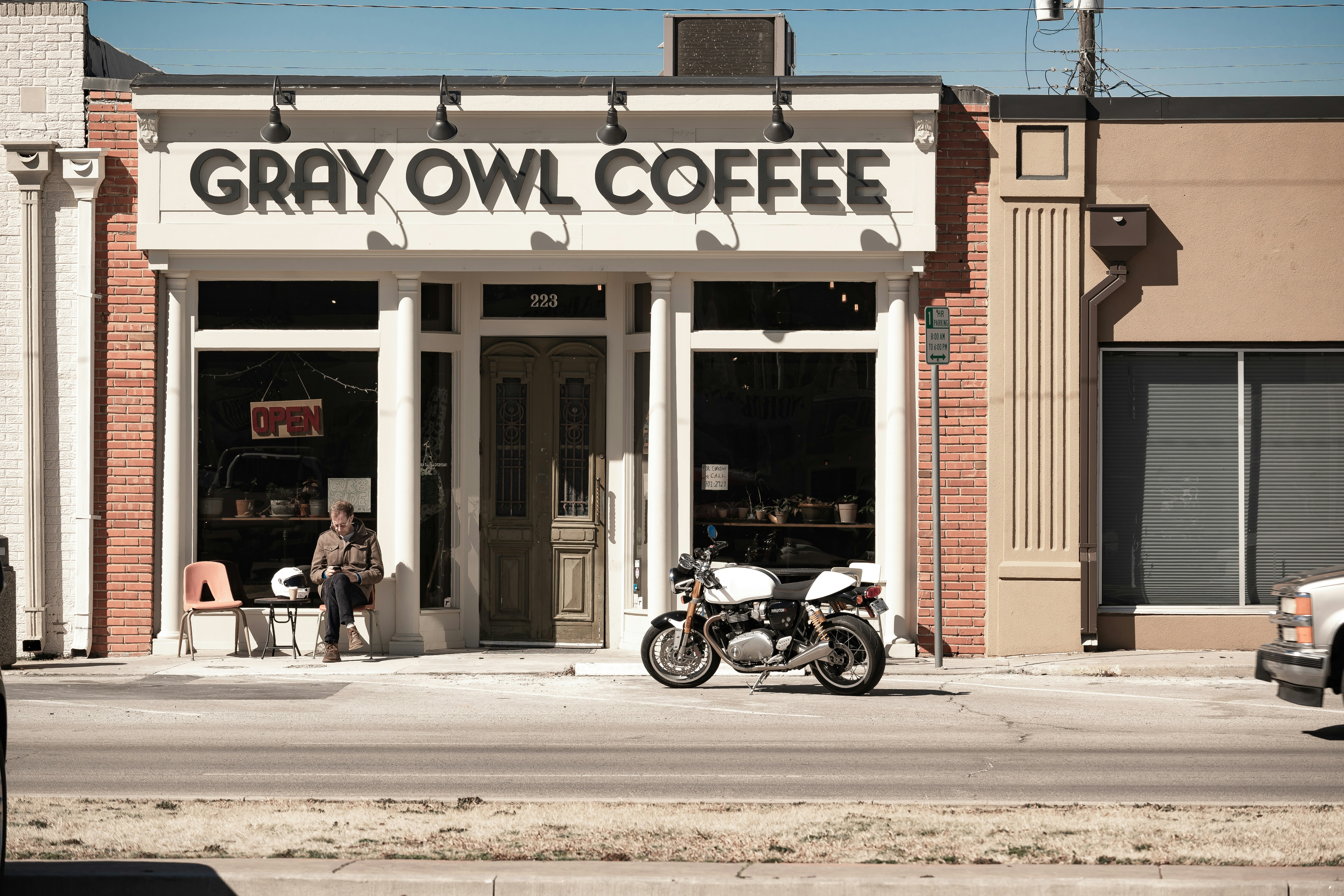 a motorcycle parked in front of a coffee shop