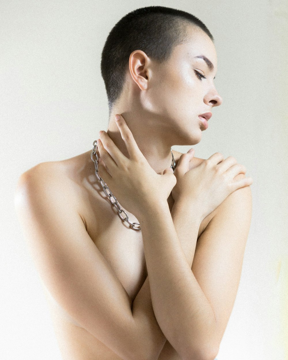 a naked woman with a chain around her neck