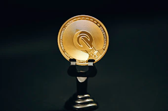 a gold coin sitting on top of a black stand