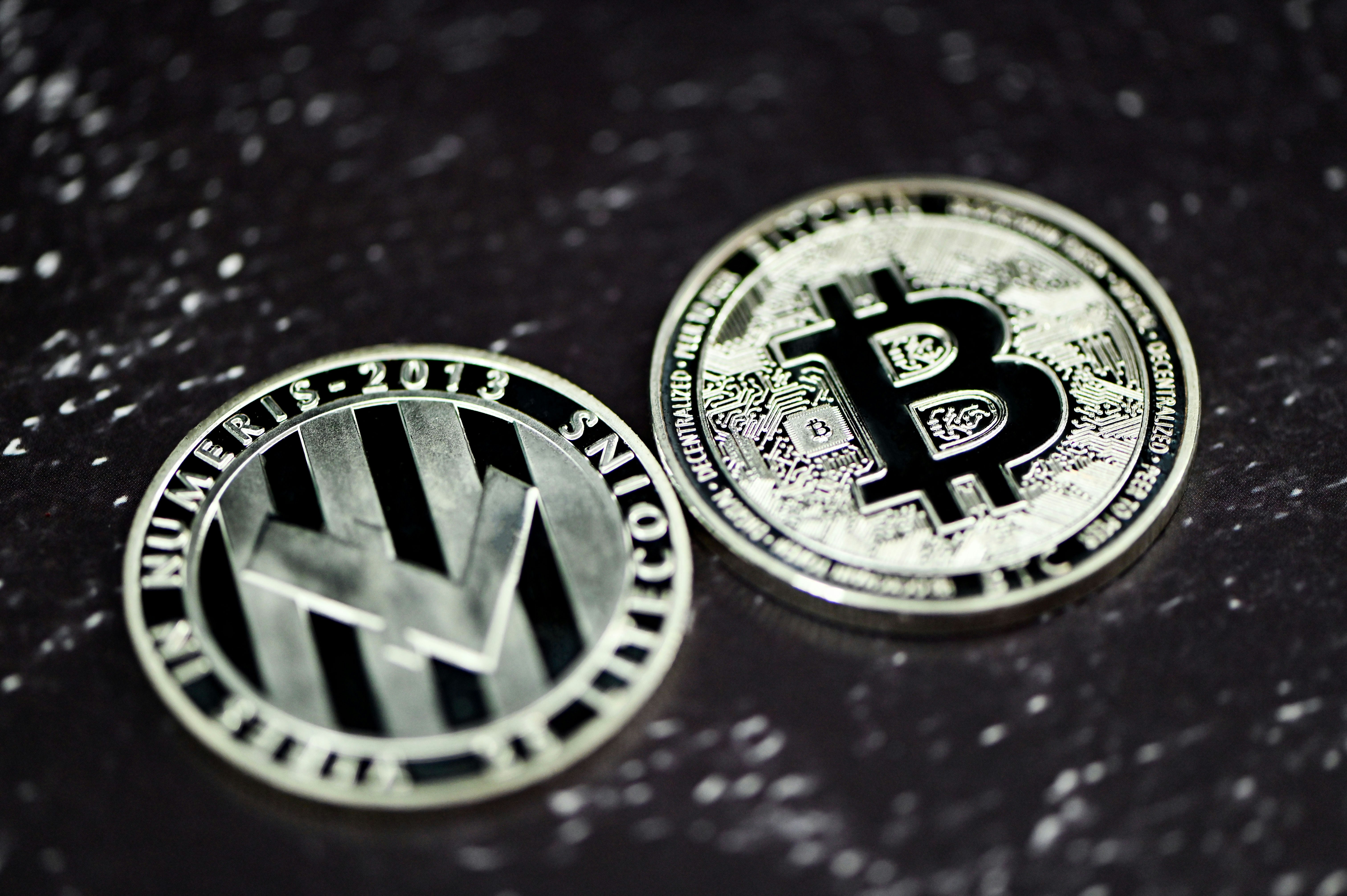 Litecoin and Bitcoin lying on a marble background