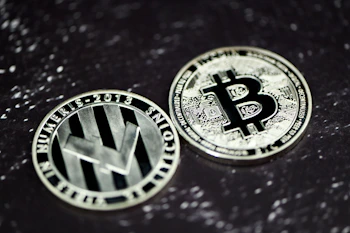 two bitcoins sitting side by side on a table