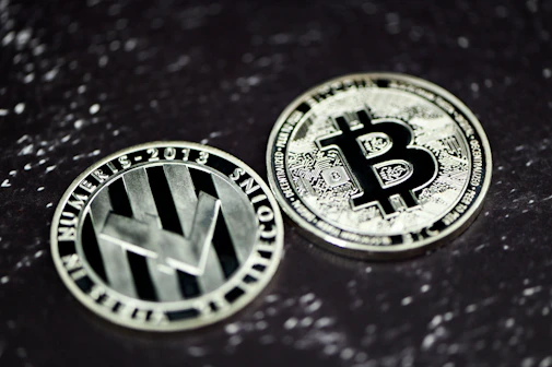 two bitcoins sitting side by side on a table