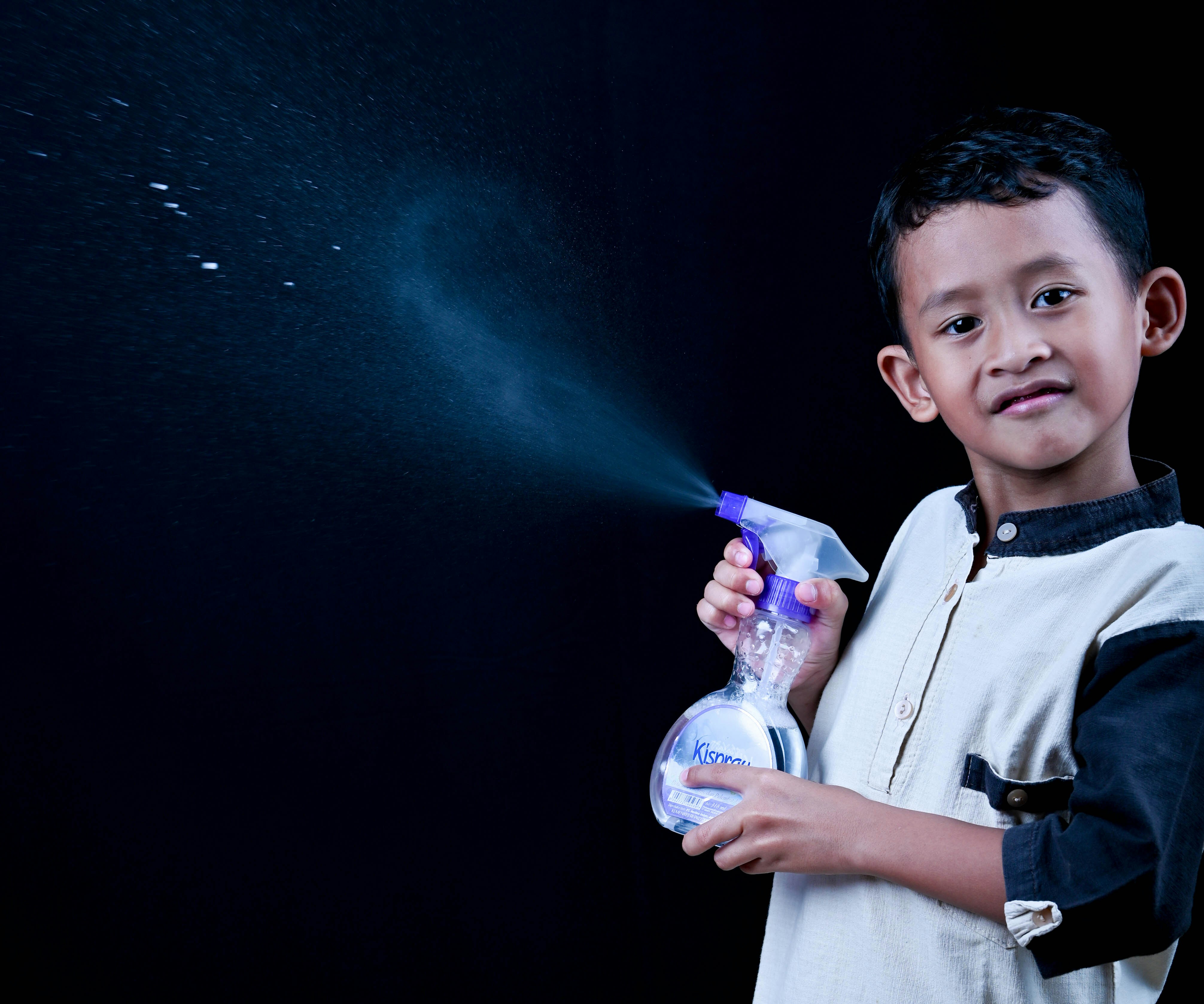 Young boy with spray bottle