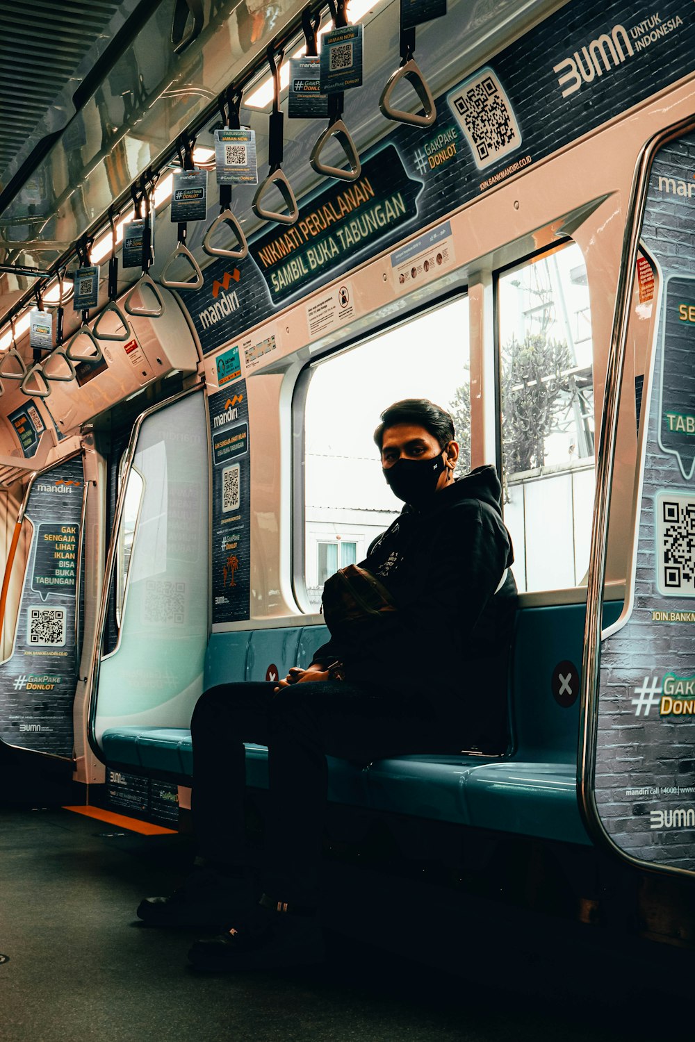 a man sitting on a subway train seat