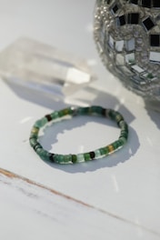 a beaded bracelet sitting on top of a table