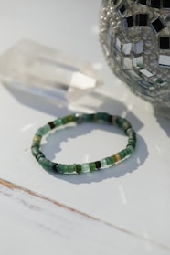a beaded bracelet sitting on top of a table