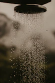a shower head with water running down it