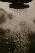 a shower head with water running down it