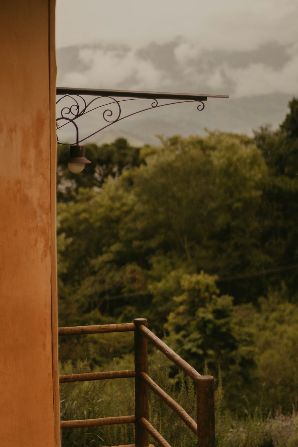 a view of trees from a balcony of a house