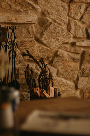 Rustic wood carving wall art hanging above a cozy living room fireplace.
