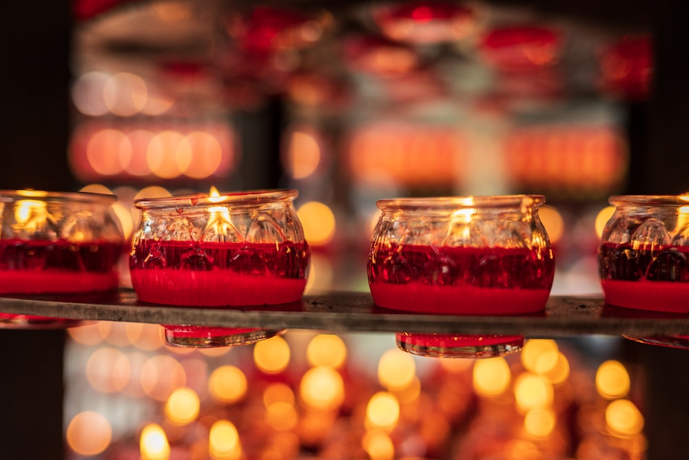 a close up of a tray of candles