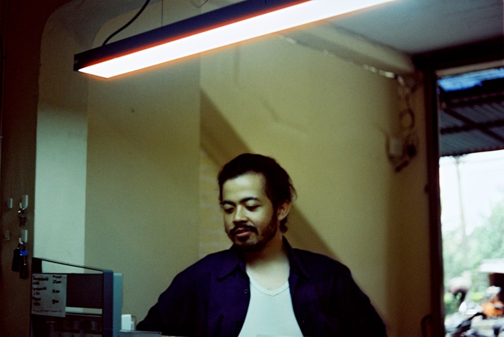 a man standing in front of a computer monitor