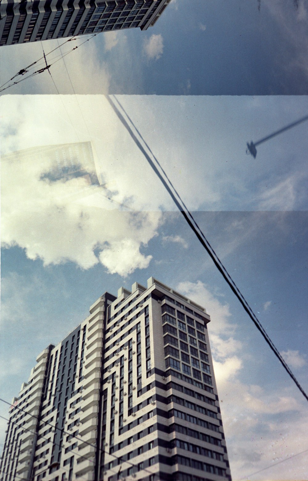 a tall building with a sky in the background