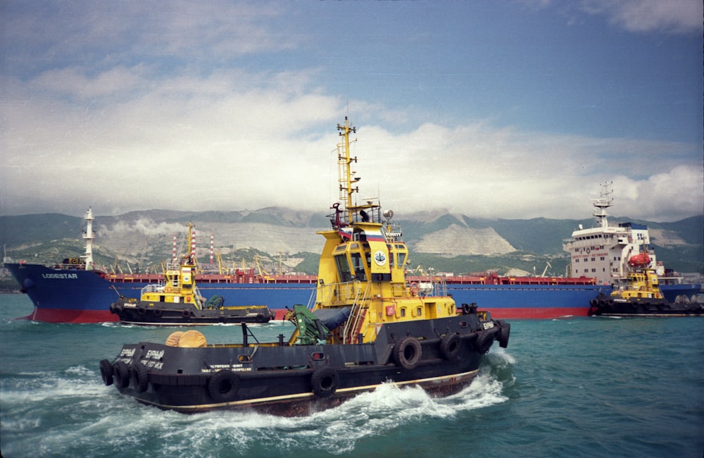 a yellow and black tug boat in the water