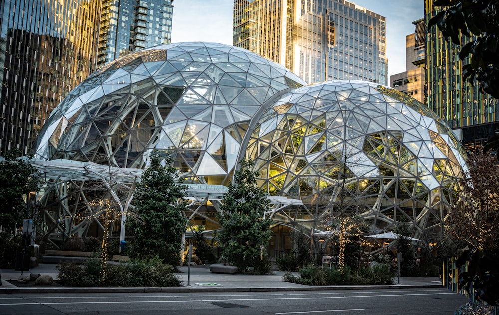 a couple of large glass domes sitting in the middle of a street