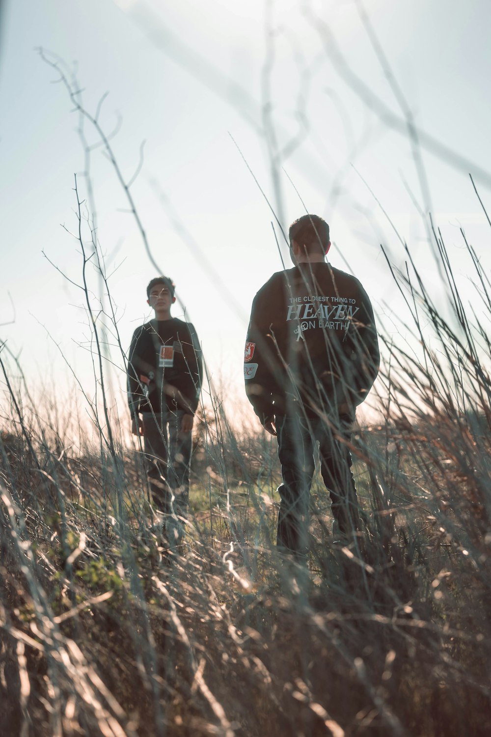 a couple of men standing next to each other in a field