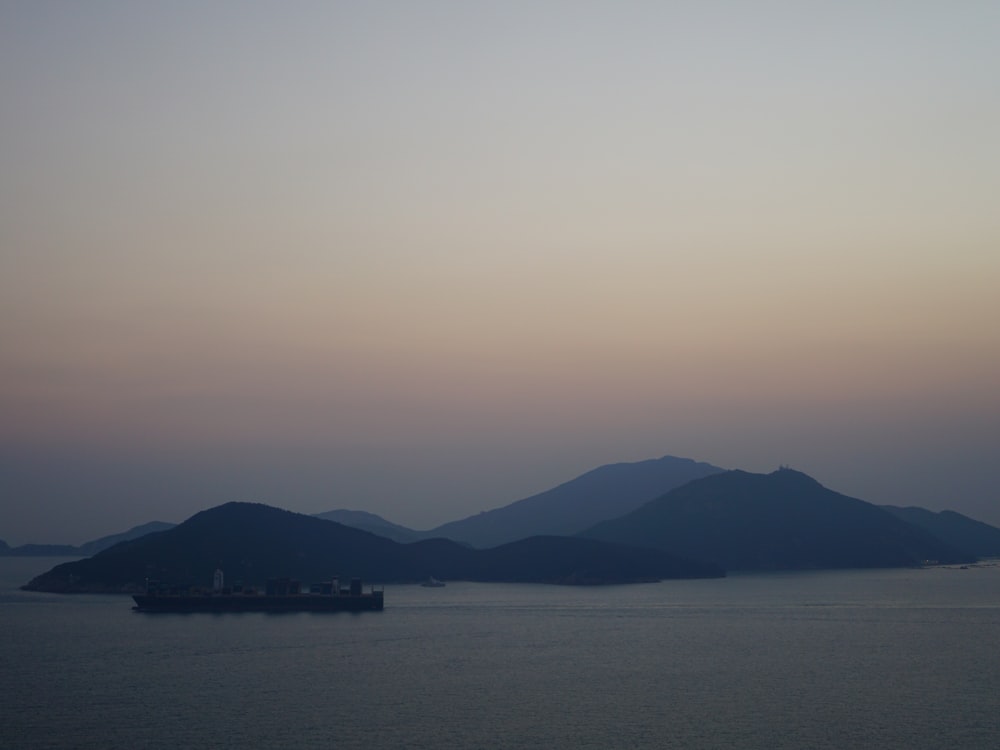 a large body of water with mountains in the background